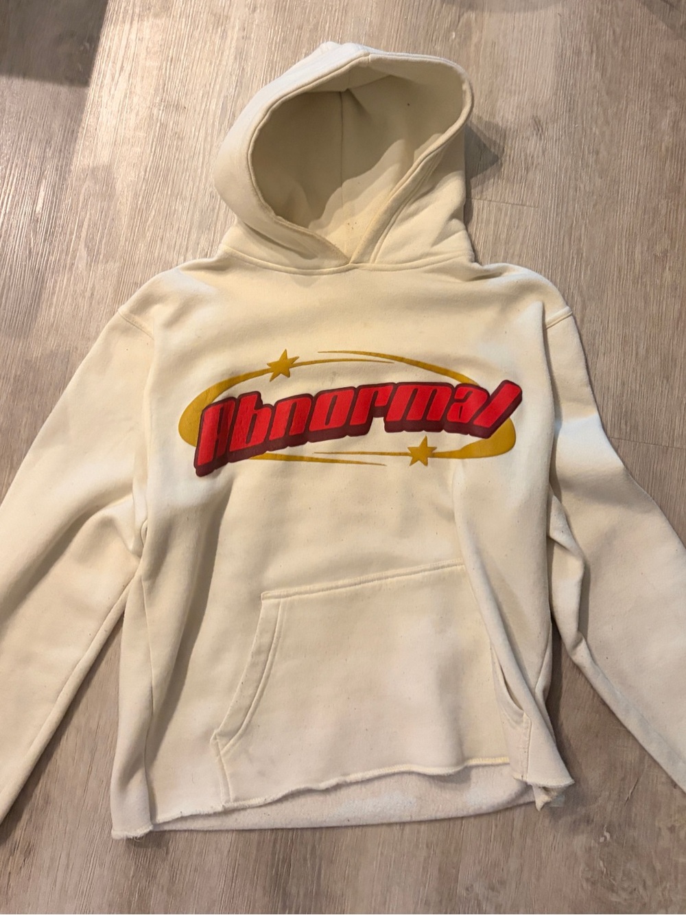 Anama Cream Crewneck Hoodie with Red and Yellow 'Abnormal' Graphic